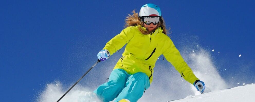 Woman skiing with Hoys rental ski gear on